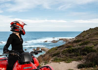 Rider on a Honda quad bike overlooking Kangaroo Island's rugged coastline during a guided tour with Kangaroo Island Outdoor Action.