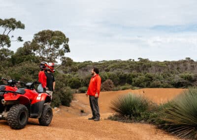 Guide leading an interpretive stop during a guided quad bike tour on Kangaroo Island