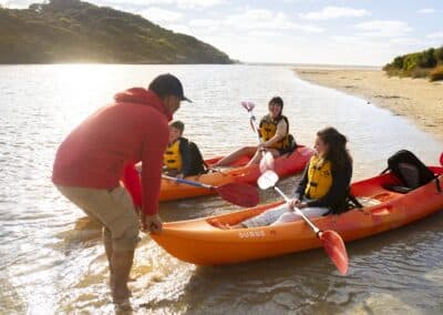 Guide assisting guests as they launch kayaks on Harriet River with Kangaroo Island Outdoor Action.