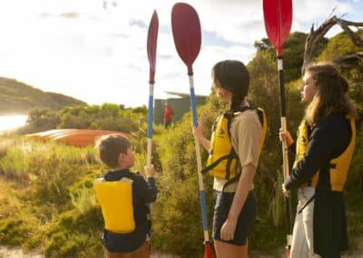 Adult and two young paddlers preparing for a guided kayak tour on Harriet River with Kangaroo Island Outdoor Action.